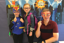 boy, girl and man holding masks over their faces