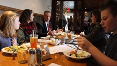 Jason Andrews, Larissa Balachick and Lizzie Hopkins sit on the left side of a restaurant table while Nora Drexler, Haley Kohlbach and Ryan Kristoff sit on the right side