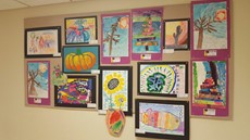 Children's art work hanging on a wall