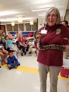 Photo of zookeeper with snake