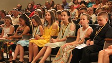 Students sitting in the front row of the auditorium