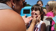 Photo of child getting her face painted