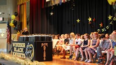 Picture of students sitting on stage during ceremony