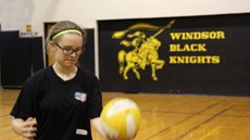 Photo of student about to serve a volleyball