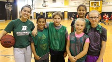 Binghamton University women's player poses for picture with Windsor basketball campers