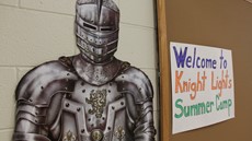 Image of Knight in armor next to "Welcome to Knight Lights" sign