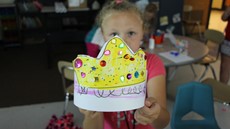 Little girl holds up a homemade crown