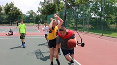 Two children playing basketball