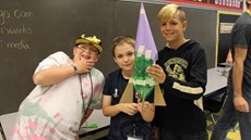 Three boys posing with their bottle rocket