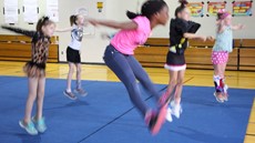 girls jumping in a gymnasium