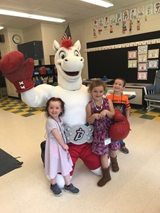 Picture of Rowdy the Pony mascot with three young children