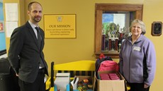 Toby Youngs and Sandy Straub standing next to donated supplies