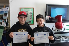 Ryan Kristof and Max DeVoe holding up certificates