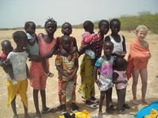 Verity Sibley standing with a group of children in Senegal