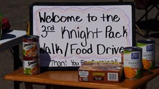 Knight Pack Walk sign on a table with food around it