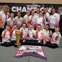 Two rows of female students in team jackets posing for picture