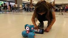 Young girl on the floor with a robot