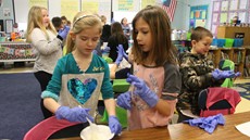 Two young girls in a classroom