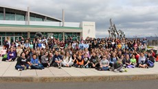 Group picture of hundreds of college and 3rd grade students in front of Binghamton University Events Center