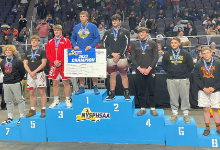 Eight high school wrestlers on a podium