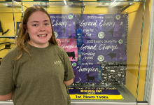 Natalia Ciborowski standing in front of championship banners