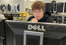 Teenage boy sitting at a computer