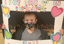 Young boy holding a sign