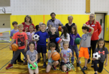 Children holding sports equipment