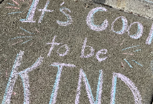"It's Cool to be Kind" written in chalk
