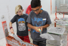 Two boys holding trowels