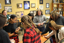 A group of teenage girls around a table