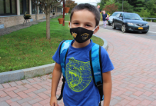 Young boy in a black facemask