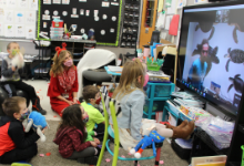 Kindergarten students looking at large screen