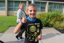 Young boy giving a thumbs up