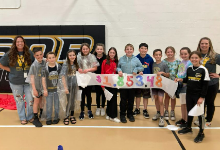 Children holding a sign
