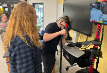 Woman watching teenage boy weld
