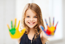 Girl with colorful paint on hands