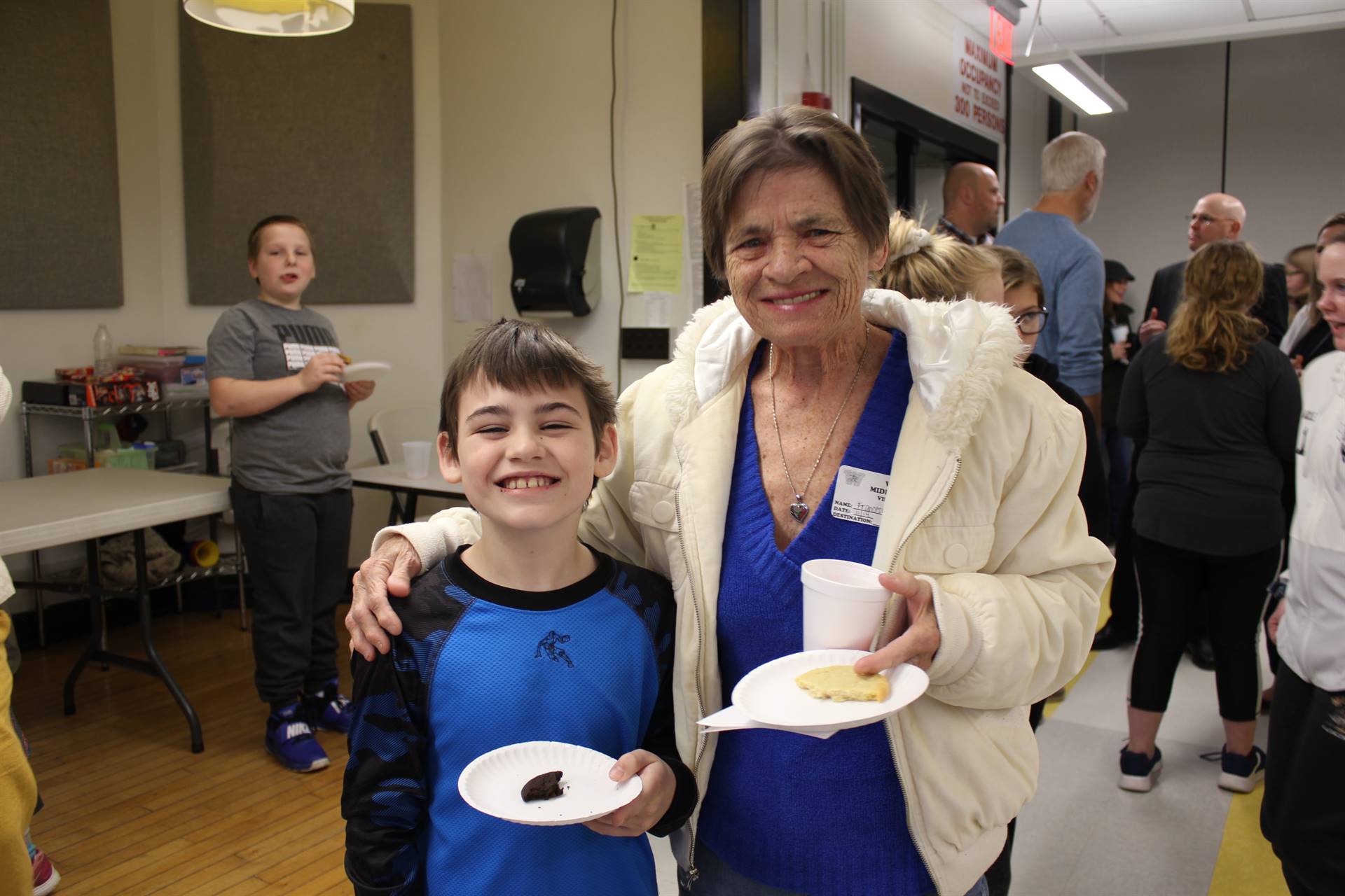 A woman standing with a young boy