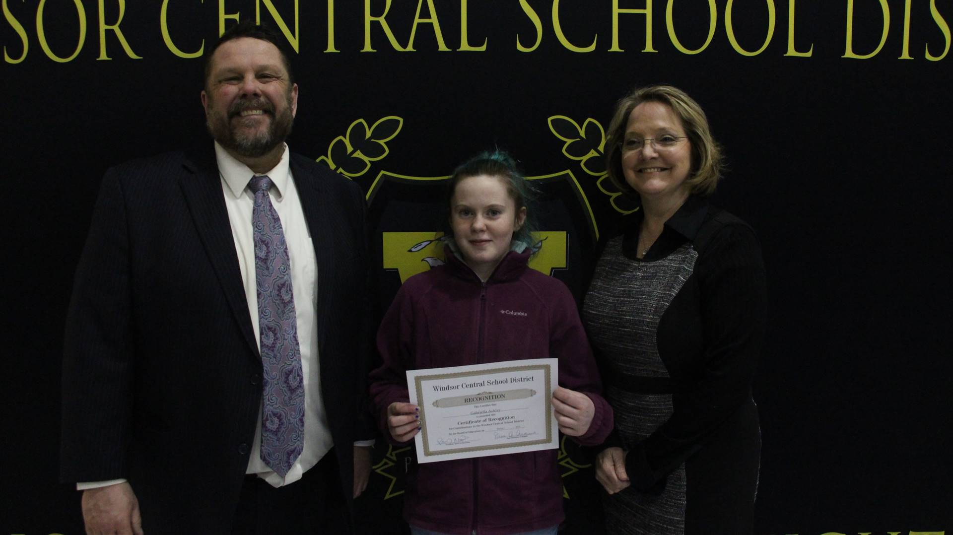 Gabrielle Ackley standing between Pete Nowacki and Margo Kibbler