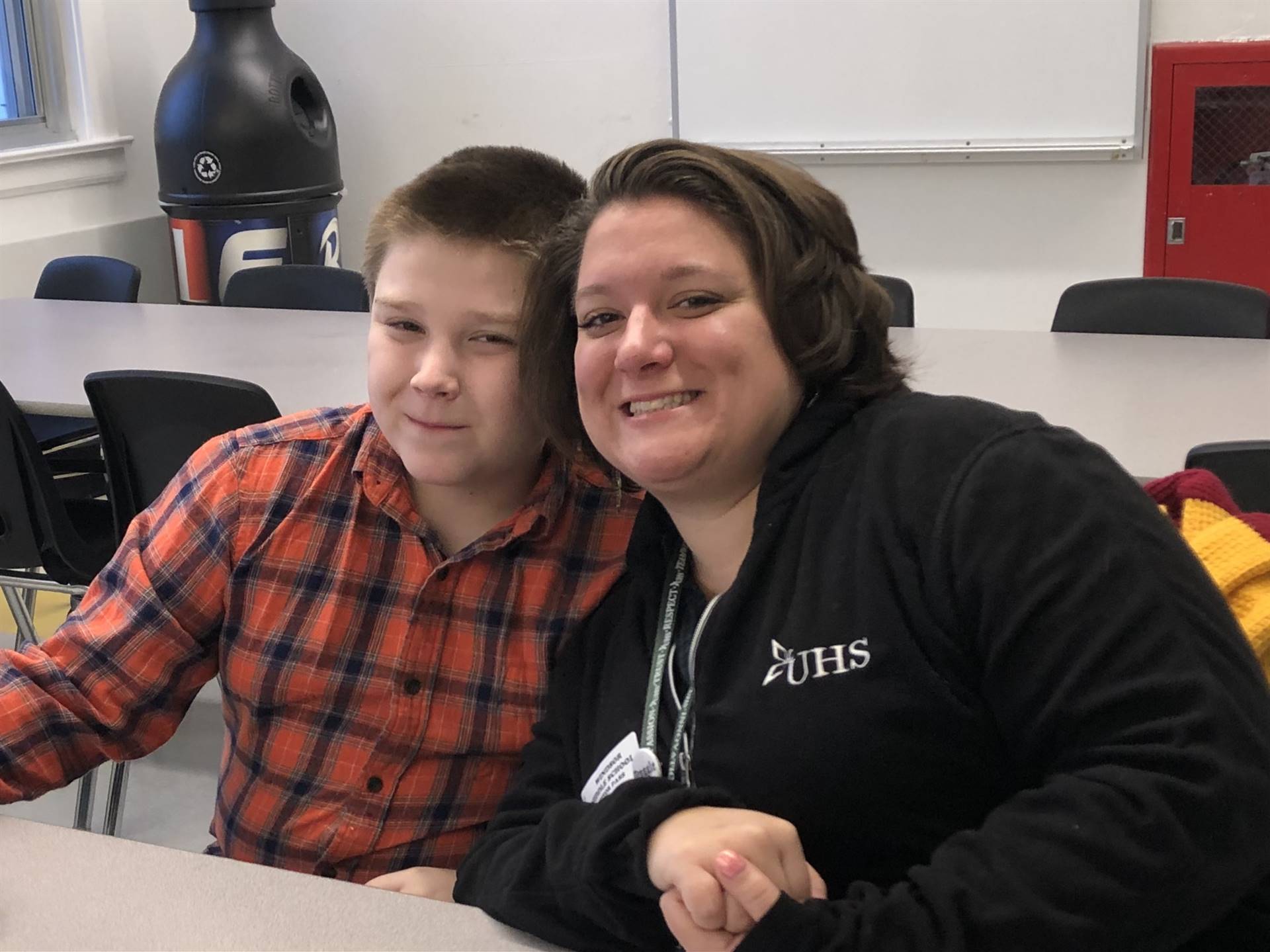 A woman sitting next to a boy