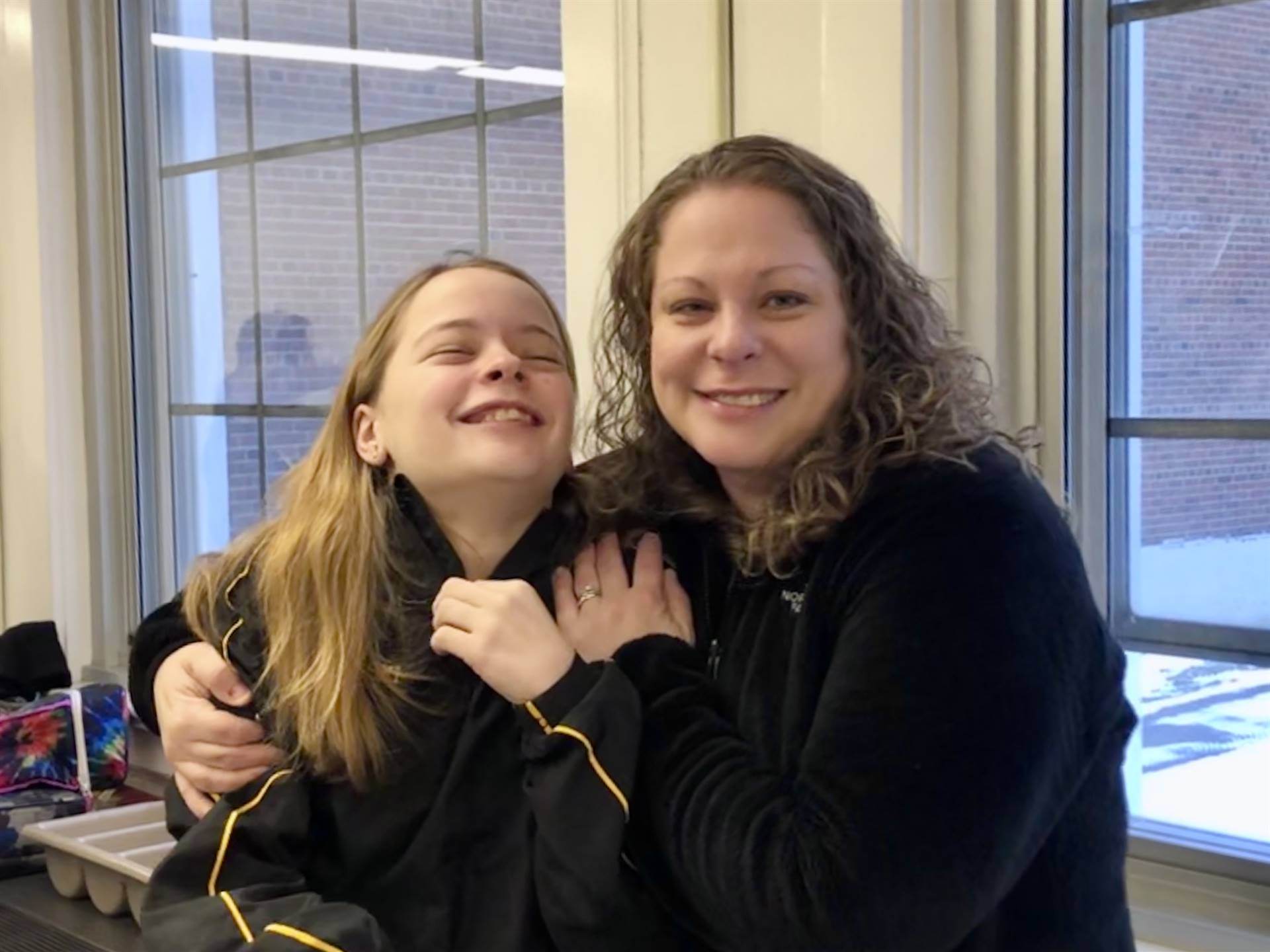A woman and a girl smiling