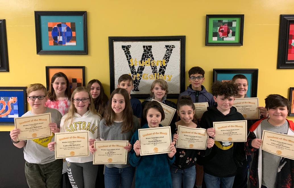 Two rows of young students holding certificates