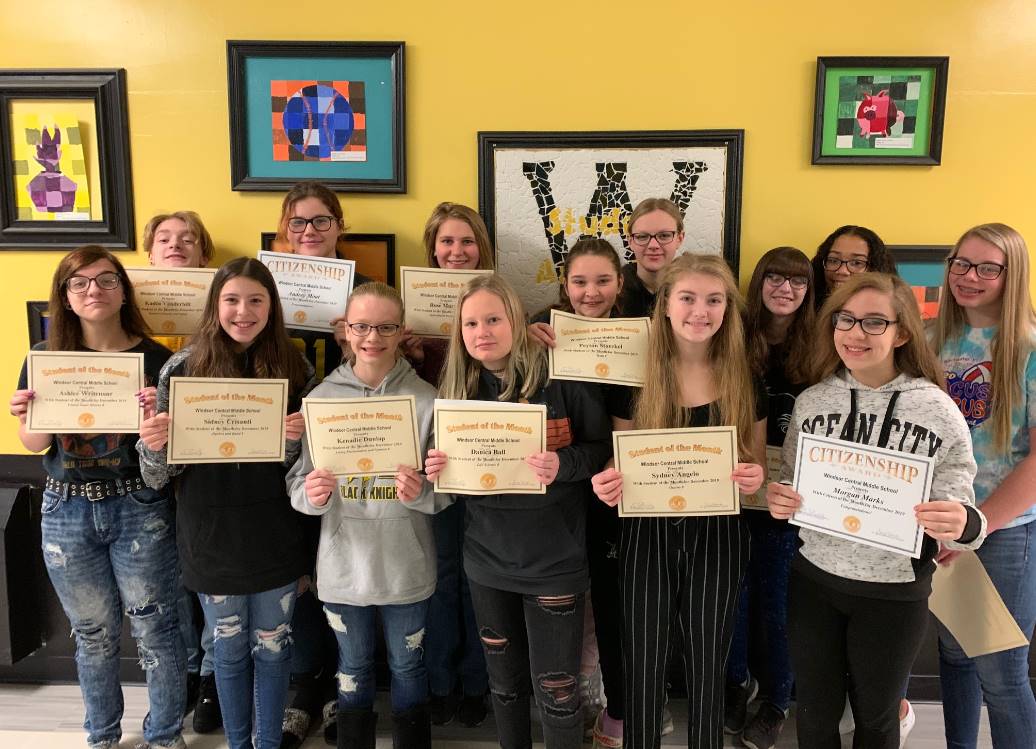 Two rows of young students holding certificates