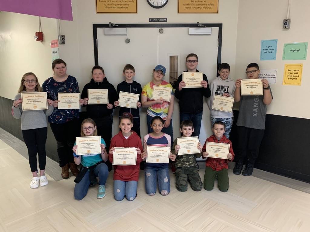 Two rows of 6th grade students holding certificates