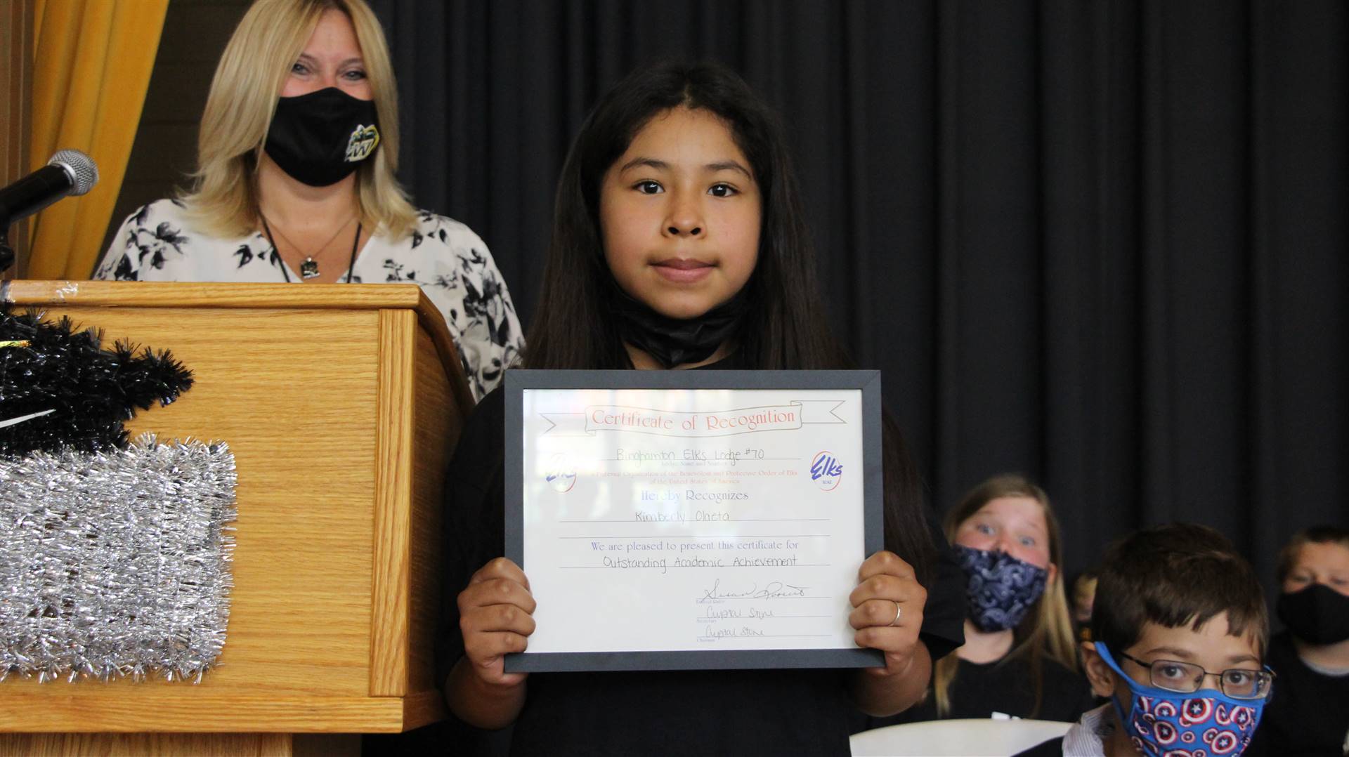 Young girl holding a certificate