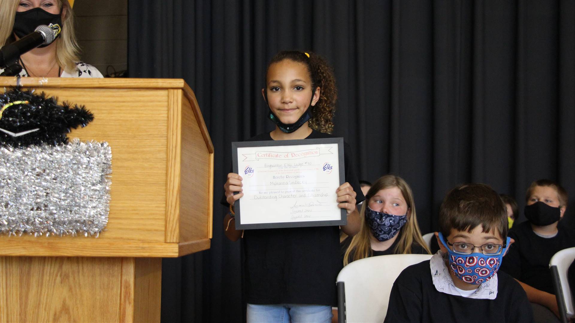Young girl holding a certificate