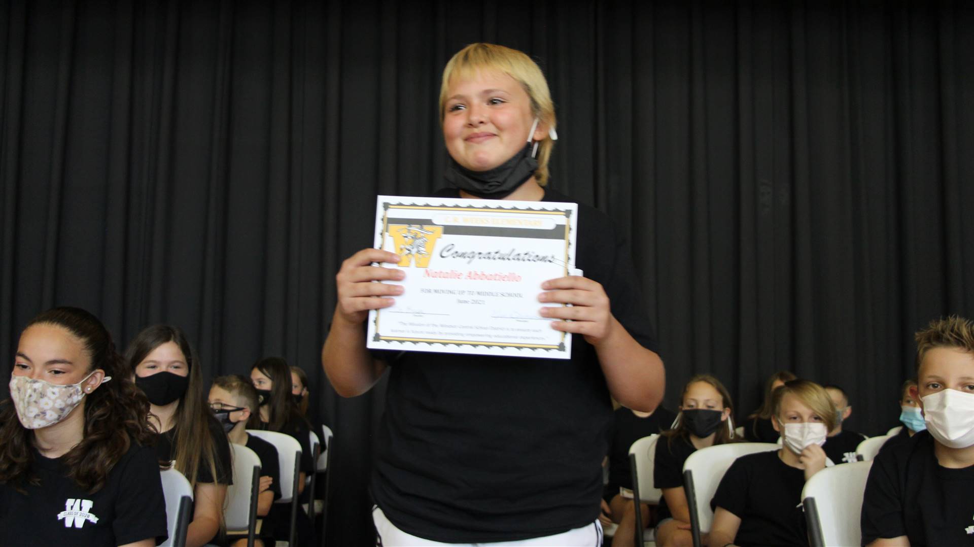 Young student holding a certificate
