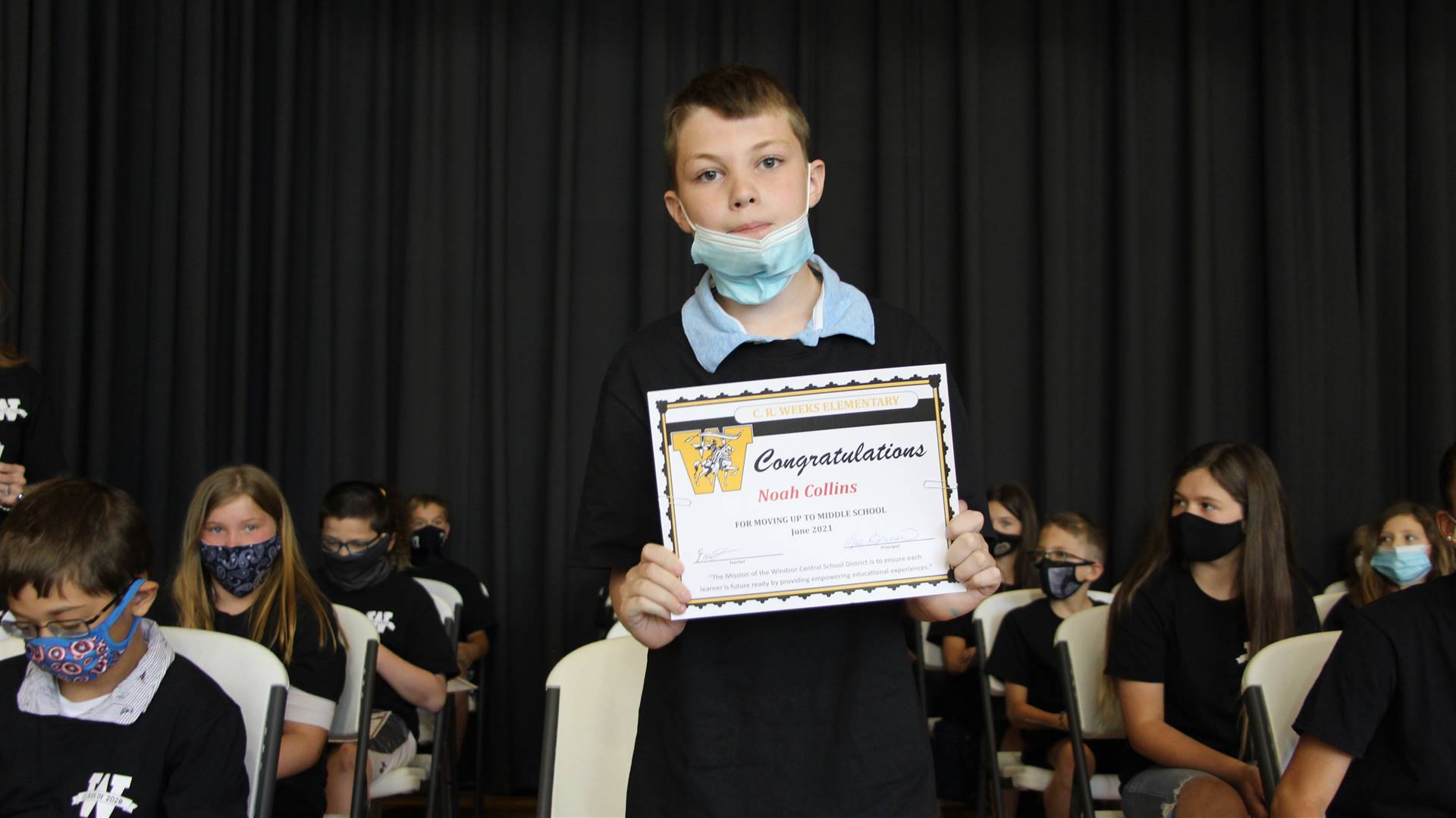 Young boy holding a certificate