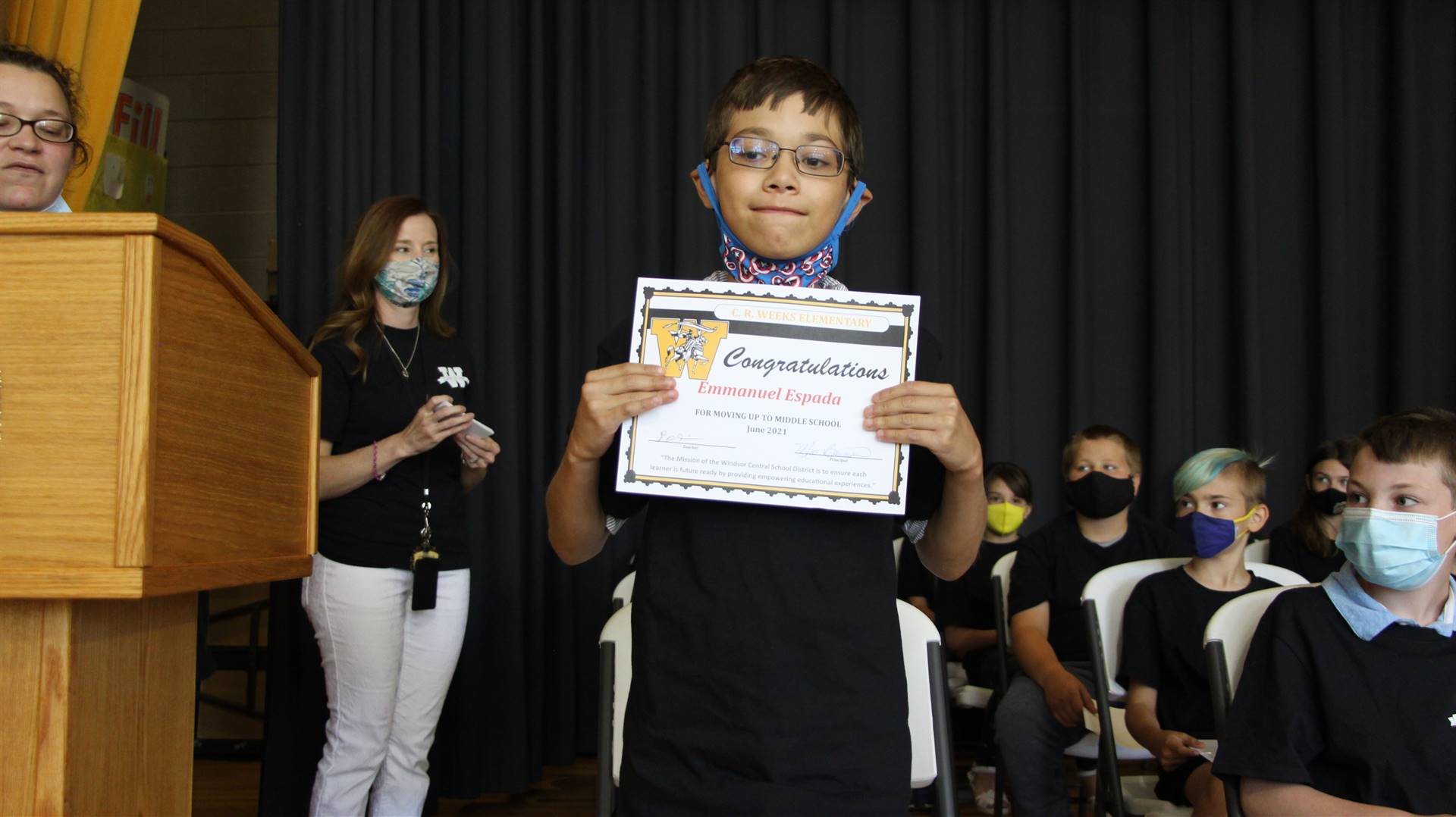 Young boy holding a certificate