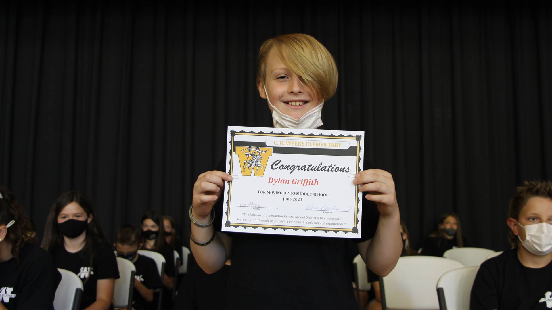 Young boy holding a certificate
